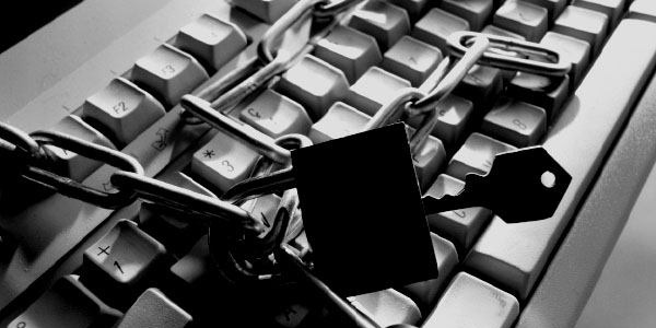 Computer keyboard with chain and padlock to puncuate the need for asset management policies.