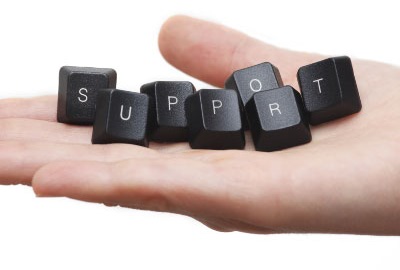 Image of open hand with keyboard keys spelling 'support' depicting the need to provide customer service satisfaction.