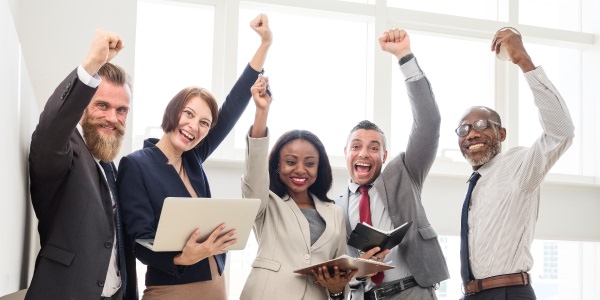 Image of a group of people gesturing 'thumbs up' signifying a successful project closure.