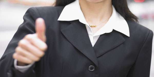 Image of woman giving the 'thumbs up' sign giving the nod to project quality management.