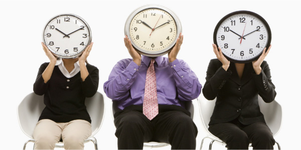 Image of three people with clocks if front of their faces emphasizing the need for relevant time management tips.